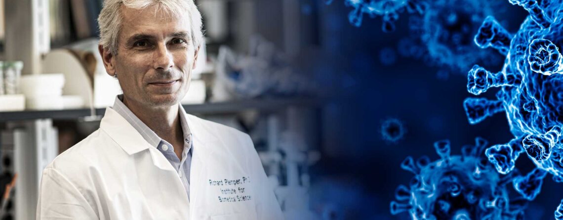 Georgia State professor Richard Plemper in his lab with an image of a virus moving in from the right