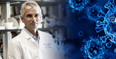 Georgia State professor Richard Plemper in his lab with an image of a virus moving in from the right