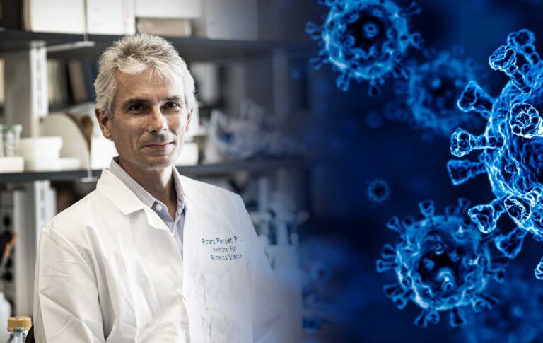 Georgia State professor Richard Plemper in his lab with an image of a virus moving in from the right