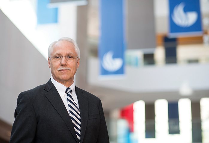 White Older Male with Classes against faded out background