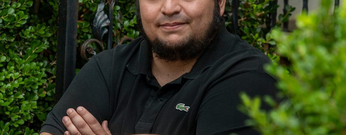 Juan Banda posing on front porch.