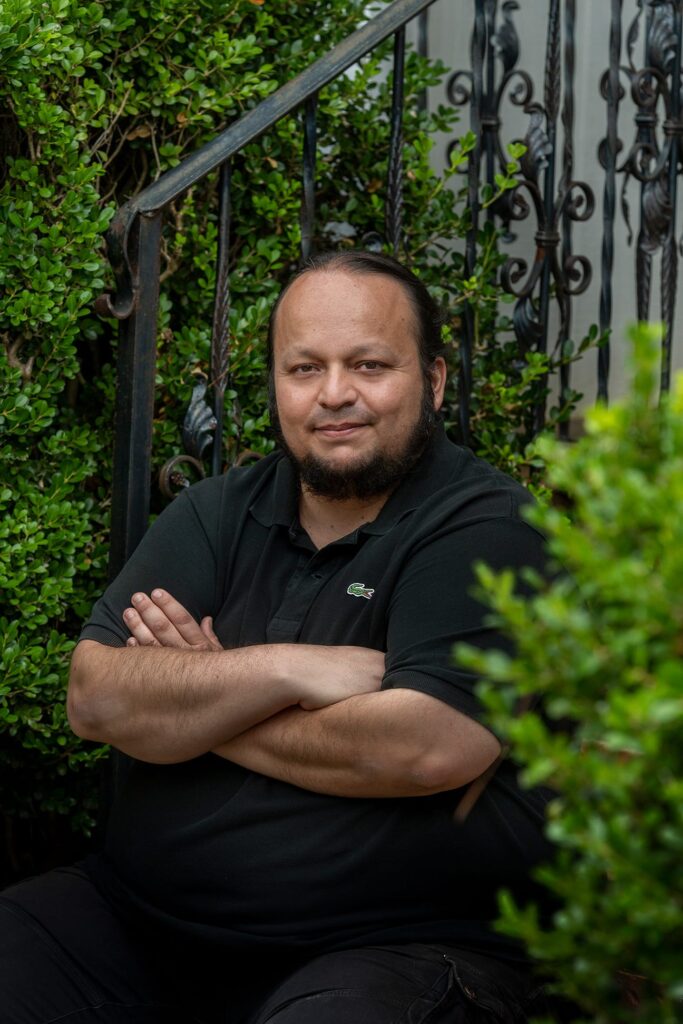 Juan Banda posing on front porch.