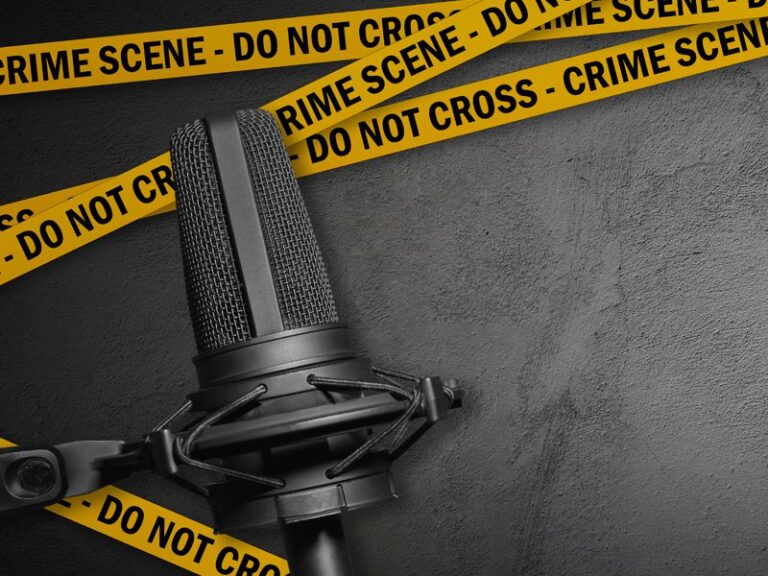 Image of a podcast microphone with yellow crime scene tape on a grey background