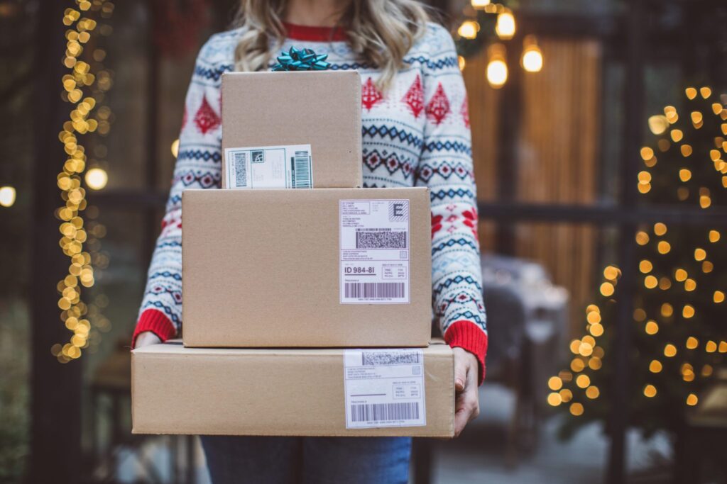 Woman holding holiday packages she purchased online