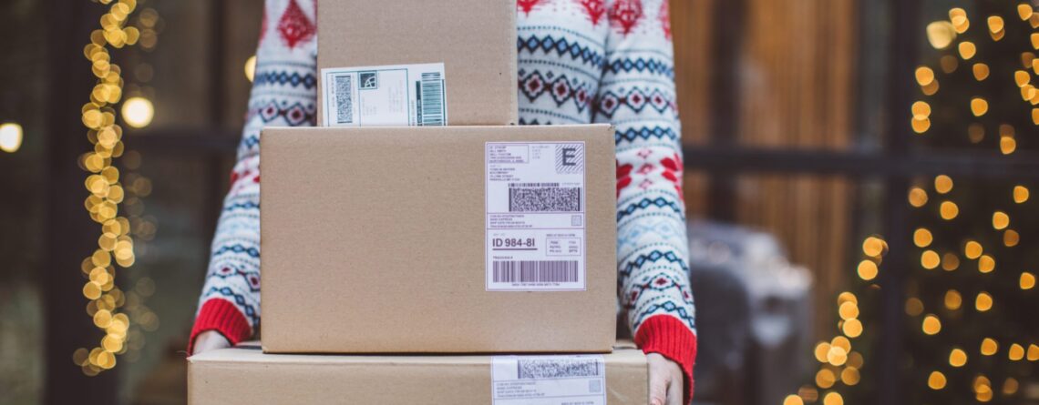 Woman holding holiday packages she purchased online