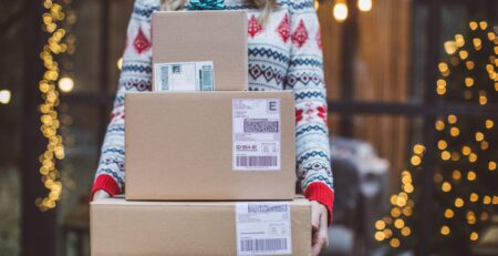 Woman holding holiday packages she purchased online