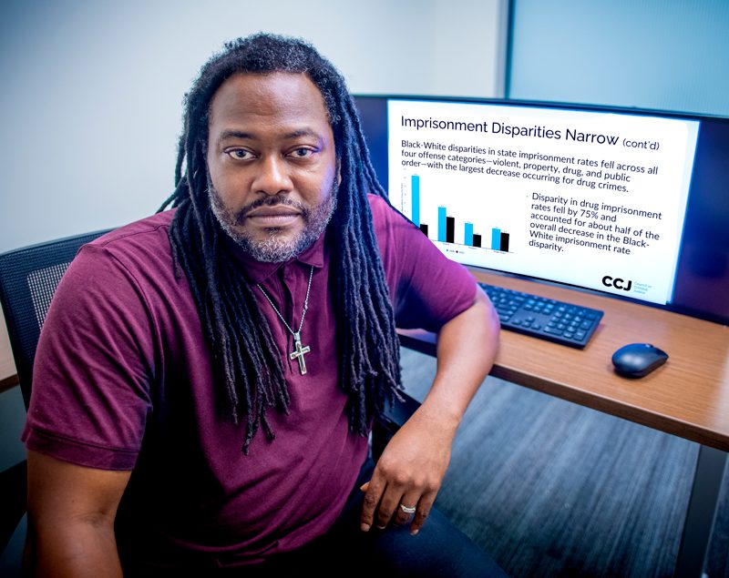 Thaddeus Johnson poses in his office